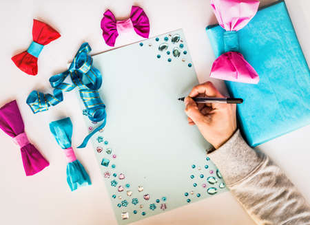 christmas concept. hand made to do list. woman hand writing in a beautiful christmas paperの写真素材