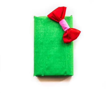 bright green hand made gift box with nice crepe wrapping and red bow. Happy holidays. christmas conceptの写真素材