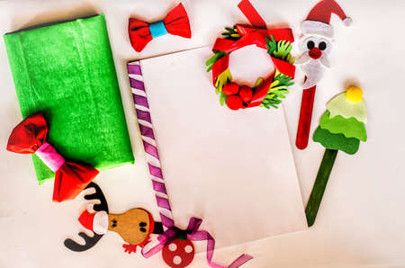 christmas concept. hand made to do list. creative christmas paper for letter,invitation or to do list with xmas bookmarks and bowsの写真素材