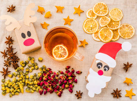 Christmas hand made reindeer and santa gift boxes, top view. Christmas or new year holiday background. Christmas present on linen table cloth backgroundの写真素材