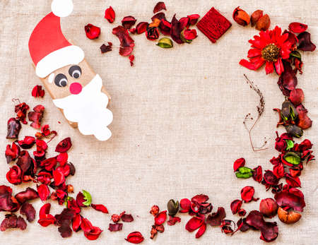 ecological christmas hand made wrapping from recycled paper on linen background in frame of flowers and dry herbsの写真素材