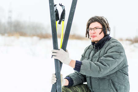 young man with warm headphones skiing in winter outsideの写真素材