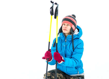 winter sports.young woman in a funny hat holding skis outdoors in snowy weatherの写真素材
