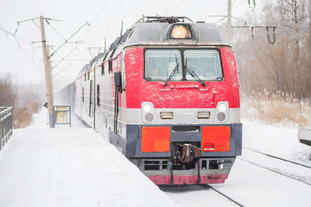 railroad train is coming outside snowy weatherの写真素材