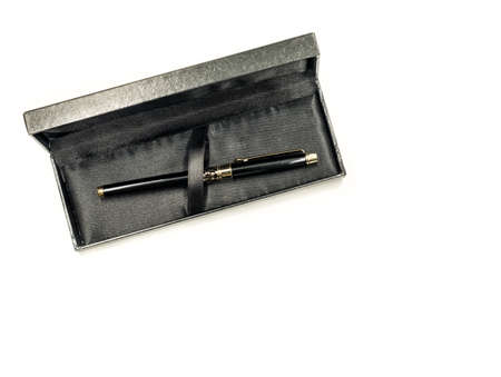 expensive black ink pen in the box isolated on whiteの写真素材