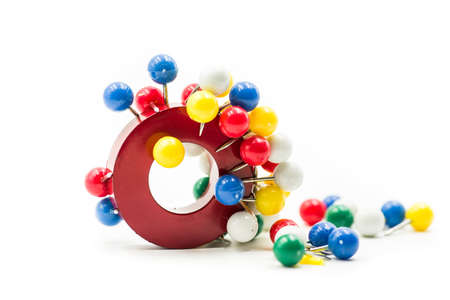round red and blue magnet attracting metal paper pins isolated on whiteの写真素材