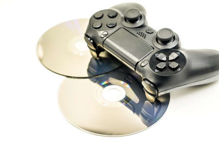 black game controller and cds isolated on whiteの写真素材