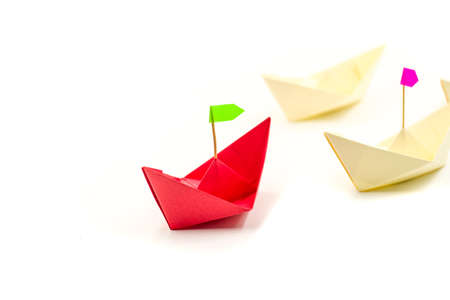 leadership concept. origami paper boat leader with a flad leading white ships. Rivalry, business, success and efficiency conceptの写真素材