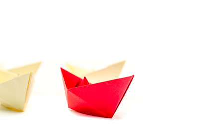 leadership concept. origami paper boat leading white ships. Rivalry, business, success and efficiency conceptの写真素材