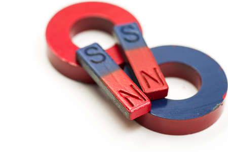four red and blue magnets isolated on white backgroundの写真素材