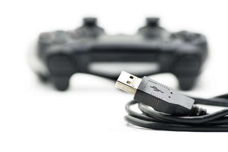 game controller with a usb line isolated on white backgroundの写真素材