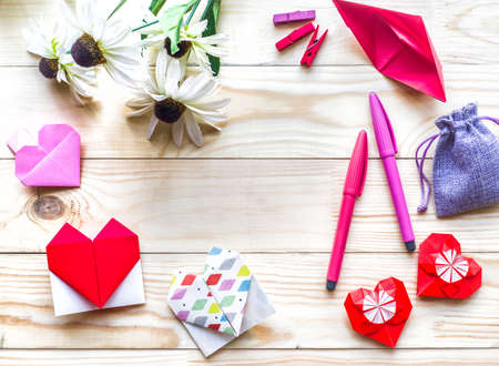 Valentines Day Decoration. paper hearts, pens, gift and flowers on wooden backgroundの写真素材