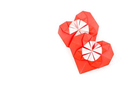 valentine's day. two red origami hearts isolated on white backgroundの写真素材