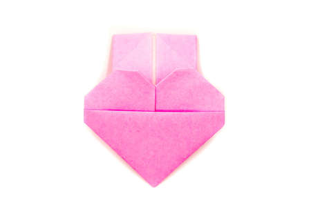 valentine's day. a pink origami heart isolated on white backgroundの写真素材