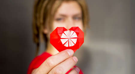 pretty woman with dreadlocks with a origami red heart, for Valentines dayの写真素材