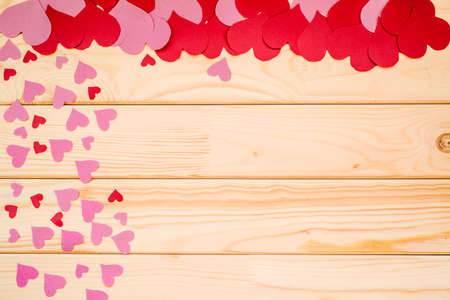 valentine's day paper hearts and confetti on rural wooden backgroundの写真素材
