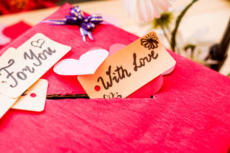 valentine's day holiday. red box for valentines with paper hearts. valentine messages and gift cardsの写真素材