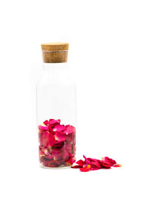 valentine's day. rose petals in the glass vase isolated on whiteの写真素材