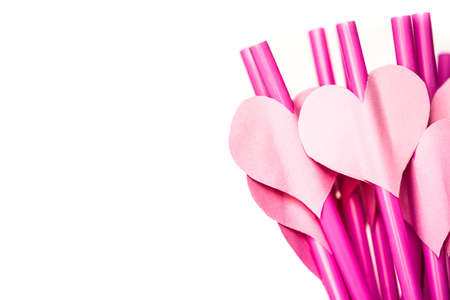 valentine's day holiday. pink and red sipping straws in a glass isolatedon white backgroundの写真素材