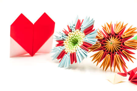 valentine day concept. module origami paper flowers craft and red valentine heart isolated on white backgroundの写真素材