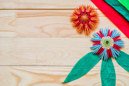 module origami flowers with crepe paper on wooden backgroundの写真素材
