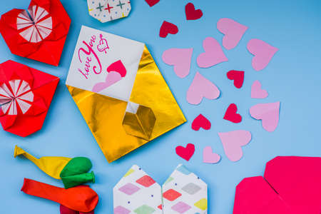 party set of colorful balloons, origami paper hearts, envelopes onblue background. valentine day setの写真素材