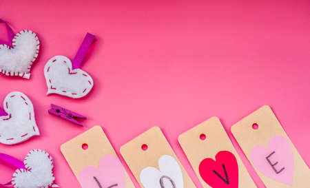 valentines day holiday. lovely hand made decorations for a valentine day on pink background. i love you labels and origami heartsの写真素材