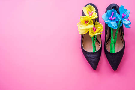 women day concept. elegant floral composition in black lady high heel shoes on pink backgroundの写真素材