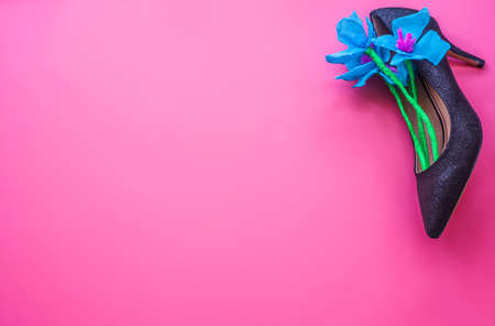 women day concept. elegant floral composition in black lady high heel shoe on pink backgroundの写真素材
