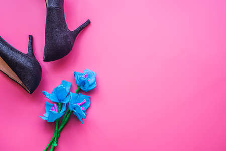 women day concept. elegant women black shoes and paper flowers on pink backgroundの写真素材