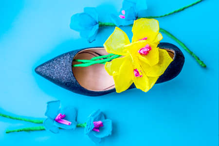 lady's high heels with paper flowers on blue background, top viewの写真素材