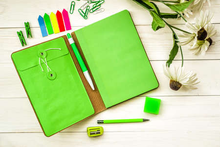 green creative and stylish stationary set on white wooden backgroundの写真素材