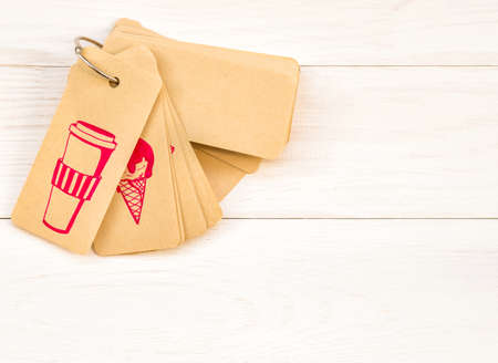 Paper label with cute pink drawings on white wooden backgroundの写真素材