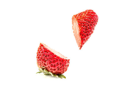 cut strawberry in the air isolated on white backgroundの写真素材
