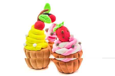 fake plasticine cupcakes crafts isolated on white backgroundの写真素材