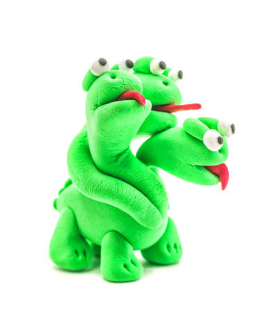 green hand made modeling clay dragon with three heads isolated on whiteの写真素材