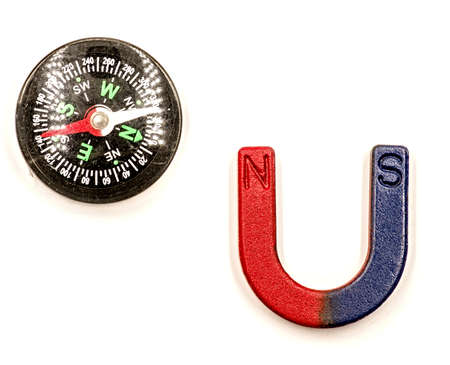 U-shaped red and blue magnet and black compass isolated on white backgroundの写真素材