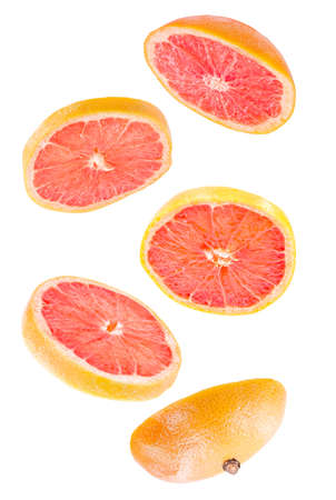 Creative concept with flying grapefruit. Sliced grapefruit isolated on white background. Levity fruit floating in the airの写真素材