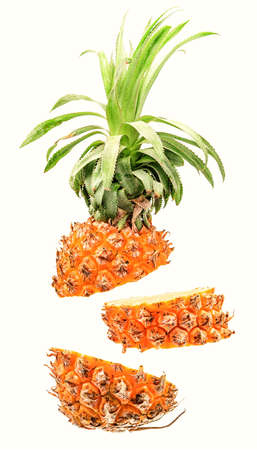 Creative concept with flying pineapple. Sliced pineapple isolated on white background. Levity fruit floating in the airの写真素材
