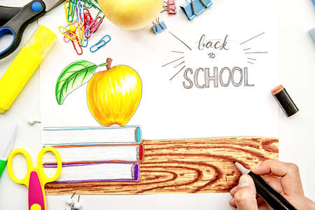 back to school concept. female hand drawing an illustration with markers. lettering back to schoolの写真素材