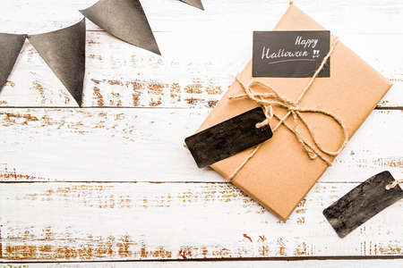 halloween gift with blacktag on white wooden table top viewの写真素材