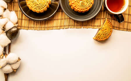 traditional chinese mid autumn festival food mooncakes with tea and cotton top view flat layの写真素材