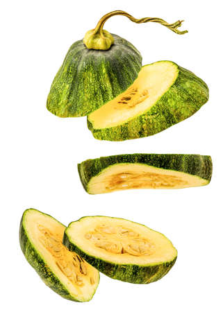 sliced green pumpkin flying isolated on white backgroundの写真素材