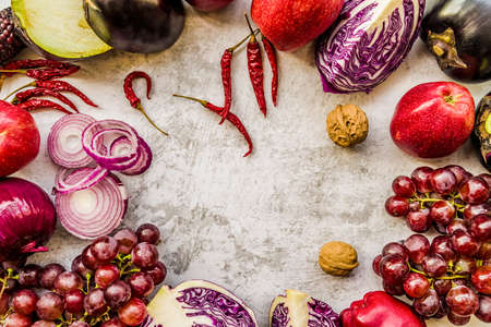 raw purple vegetables and fruit on white marble background with copy space top viewの写真素材
