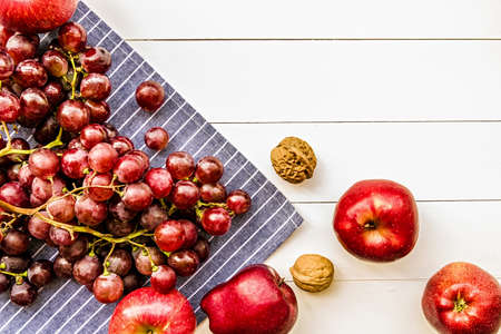 raw purple and red fruit on white wooden background top viewの写真素材
