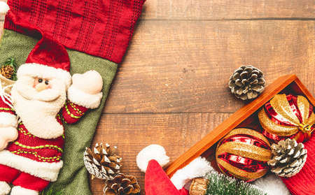 Christmas stocking and wooden box with decoartions on wooden background