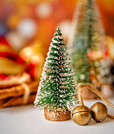 christmas and new year concept. christmas trees surrounded with decorations on bright blurry shiny...