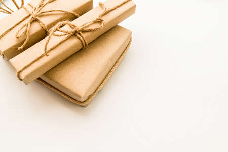 Easter gifts in craft paper and pussy-willow branches on white backgroundの写真素材