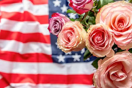 Roses over the USA flag top view. Independence Day and Memorial Day of the USAの写真素材
