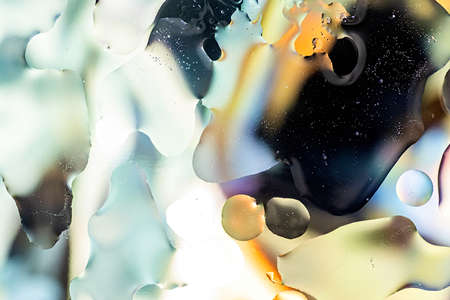 Abstract background. Black and yellow oil bubbles on waterの写真素材